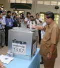Cambodia's PM and Deputy President of the ruling CPP Hun Sen drops a ballot into the box at the polling station during a local commune election in Kandal province