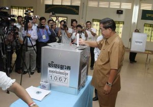 Cambodia's PM and Deputy President of the ruling CPP Hun Sen drops a ballot into the box at the polling station during a local commune election in Kandal province