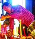 Man lighting encences in Wat Phrom during New Year in Phnom Penh