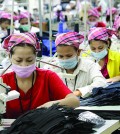 Employees work at the W & D Cambodia Co. Limited garment factory in Phnom Penh