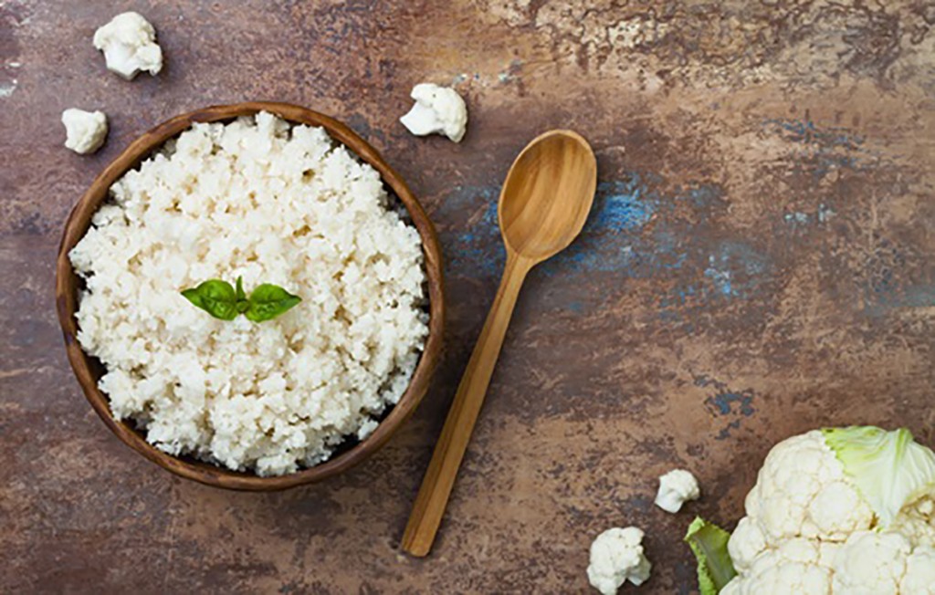 Cauliflower rice in a bowl. Top view, overhead, copy space