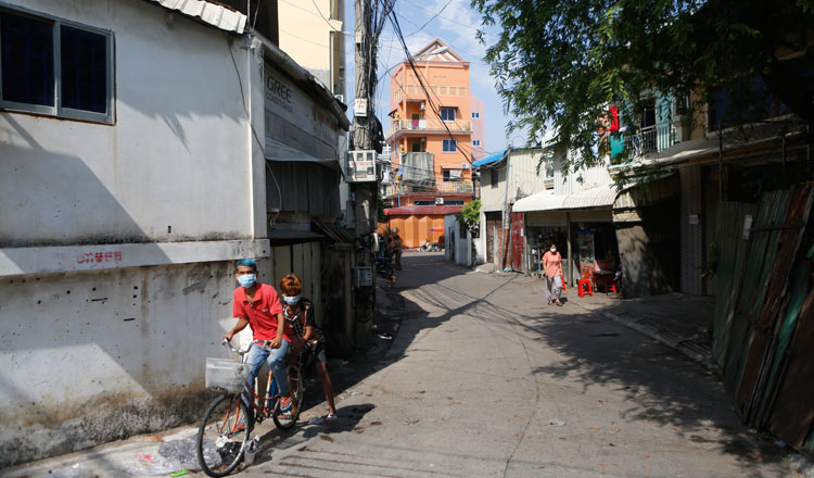 Children ride a bicycle after a Red Zone is lifted in Phnom Penh. KT/Siv Channa