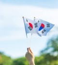hand holding Korea flag on nature background. National Foundatio