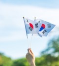 hand holding Korea flag on nature background. National Foundatio