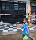 a_boy_walks_in_front_of_a_house_where_a_family_member_tested_positive_for_covid-19_in_stung_meanchey_commune_of_the_capitals_meanchey_district_last_june._hong_menea