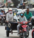 people_some_wearing_masks_and_some_not_travel_on_street_371_in_phnom_penhs_meanchey_district_on_february_14._hong_menea