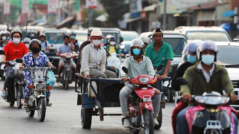 people_some_wearing_masks_and_some_not_travel_on_street_371_in_phnom_penhs_meanchey_district_on_february_14._hong_menea
