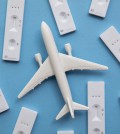 Covid travel concept. Airplane with covid19 antigen test kits