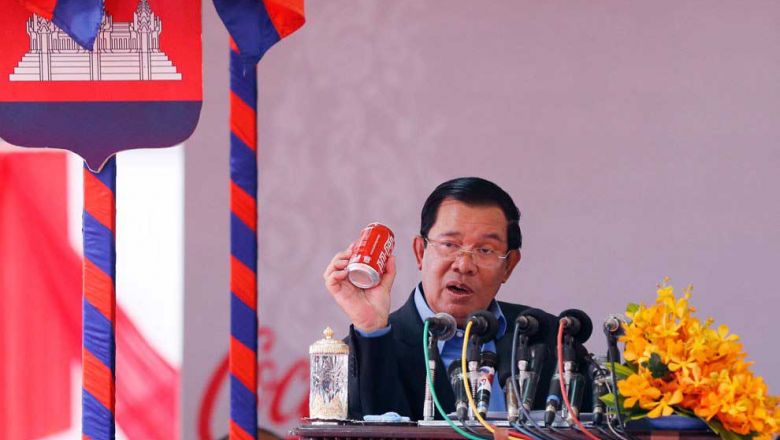 prime_minister_hun_sen_holds_a_can_of_coca-cola_at_the_2016_launch_of_the_coca-cola_factory_in_western_phnom_penh._supplied