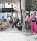 people_wait_with_their_children_outside_the_kantha_bopha_hospital_near_wat_phnom_in_the_capitals_daun_penh_district_in_june._heng_chivoan