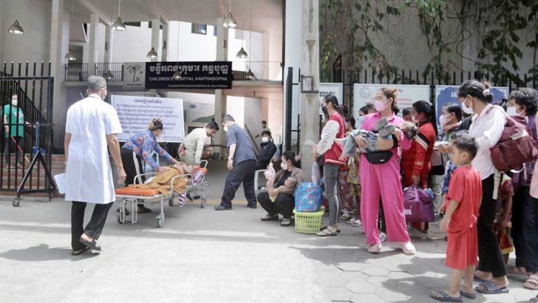 people_wait_with_their_children_outside_the_kantha_bopha_hospital_near_wat_phnom_in_the_capitals_daun_penh_district_in_june._heng_chivoan