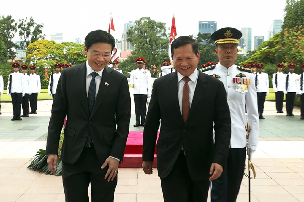 19_6_2024_singaporean_prime_minister_lawrence_wong_right_welcomes_prime_minister_hun_manet_to_singapore_on_june_18
