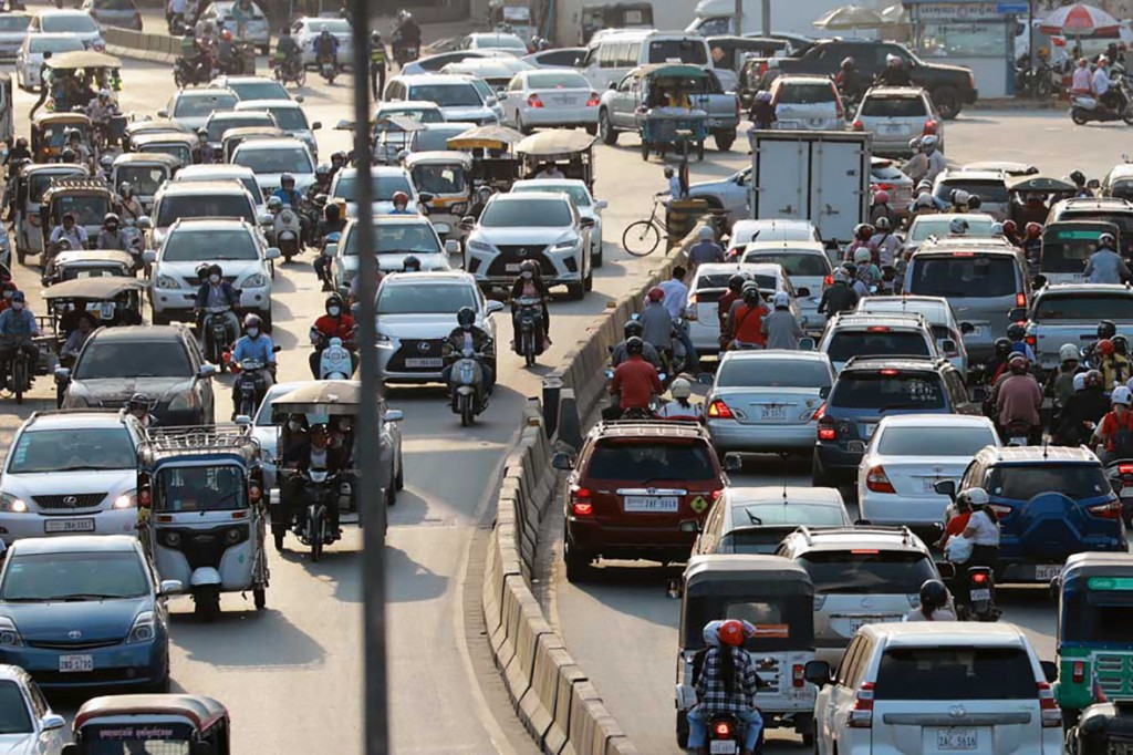 24_6_2024_24_6_2024_cars_motorcycles_and_other_vehicles_move_along_a_road_in_the_capitals_meanchey_district_in_february_last_year_hong_menea