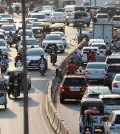 24_6_2024_24_6_2024_cars_motorcycles_and_other_vehicles_move_along_a_road_in_the_capitals_meanchey_district_in_february_last_year_hong_menea